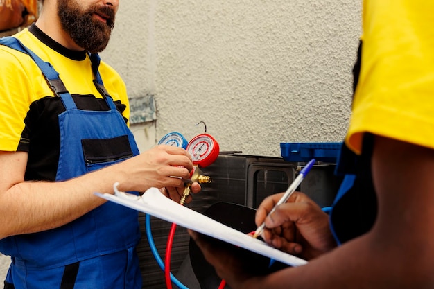 coworkers-refill-air-conditioner-freon_482257-90737 coworkers-refill-air-conditioner-freon_482257-90737