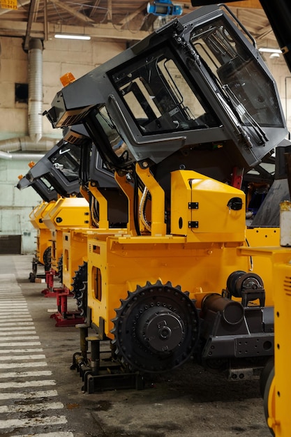 several-huge-construction-machines-yellow-color-standing-row_274679-33607 several-huge-construction-machines-yellow-color-standing-row_274679-33607