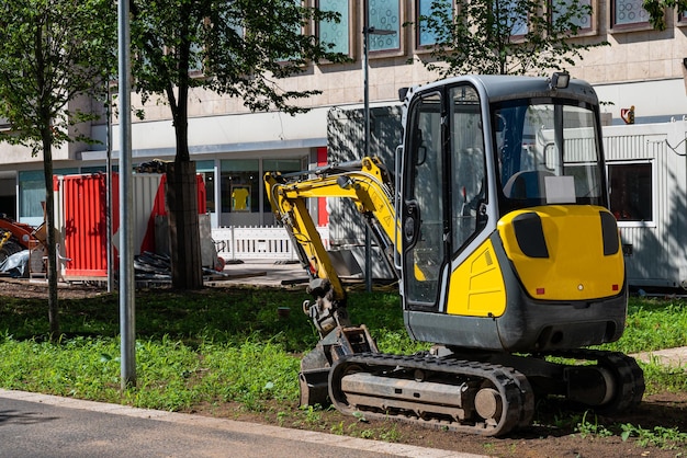 small-yellow-excavator-construction-site-city_389554-49 small-yellow-excavator-construction-site-city_389554-49
