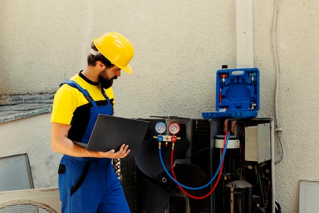 trained-engineer-tasked-with-servicing-outdoor-air-conditioner-internal-components-checking-freon-level-calibrating-thermostats-skilled-technician-looking-maintenance-plan-laptop_482257-75187 trained-engineer-tasked-with-servicing-outdoor-air-conditioner-internal-components-checking-freon-level-calibrating-thermostats-skilled-technician-looking-maintenance-plan-laptop_482257-75187